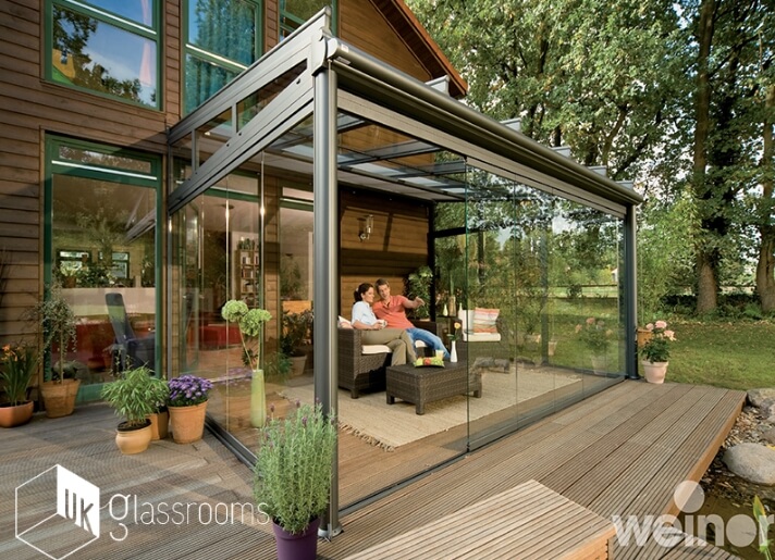 Glass outdoor room with sliding glass doors